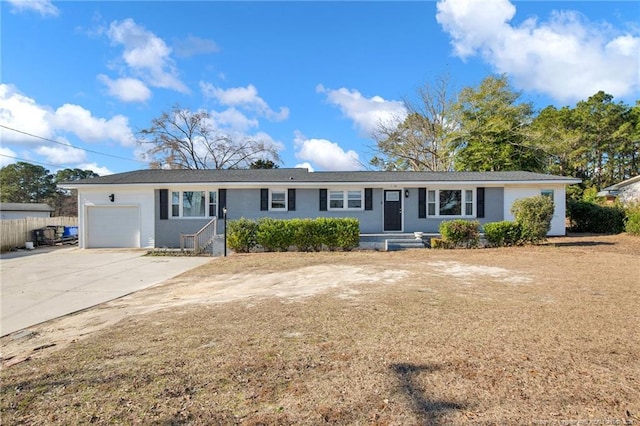 ranch-style home with a garage and driveway