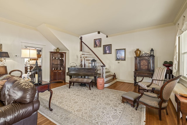 sitting room with wood-type flooring and ornamental molding