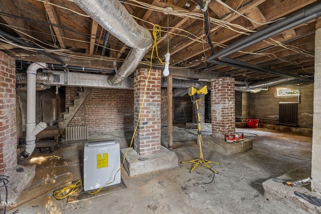 basement featuring brick wall