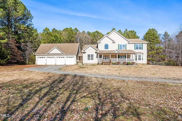 view of front of home with a front yard, a garage, and a porch