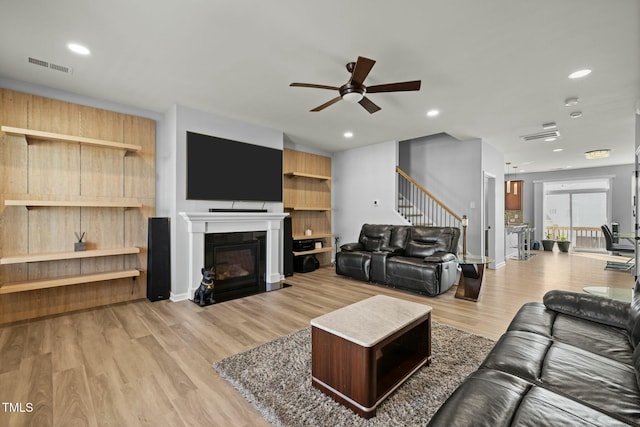 living room featuring light wood-type flooring and ceiling fan