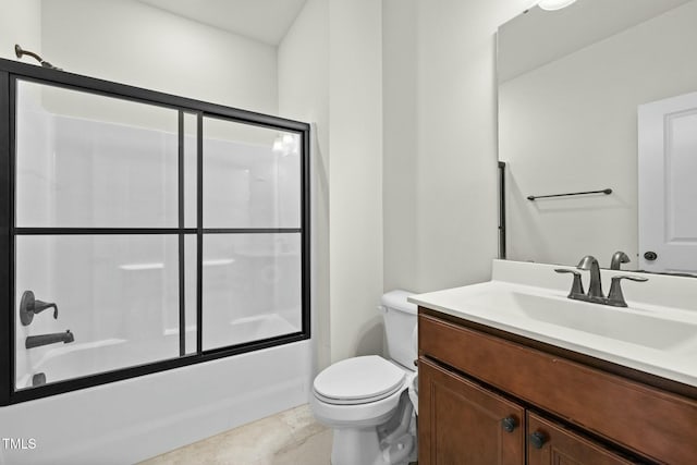 full bathroom featuring vanity, combined bath / shower with glass door, and toilet