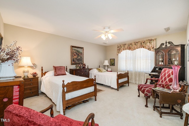 bedroom featuring light colored carpet and ceiling fan