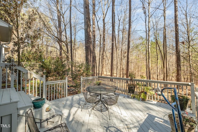 wooden terrace featuring outdoor dining area