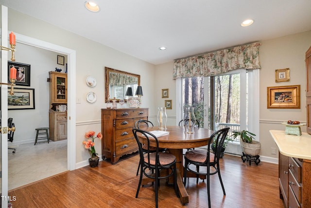 dining area featuring recessed lighting, baseboards, and wood finished floors