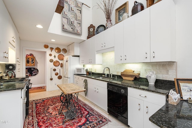 kitchen featuring a sink, white cabinetry, white appliances, light tile patterned flooring, and decorative backsplash