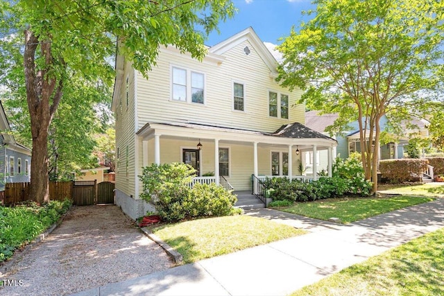216 N Bloodworth St, Raleigh, NC 27601 - view of front facade with a porch, fence, and a front yard