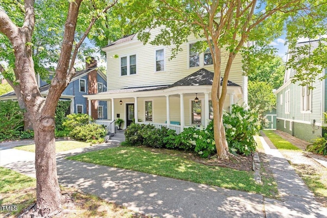 216 N Bloodworth St, Raleigh, NC 27601 - view of front of home featuring a front lawn, roof with shingles, and covered porch