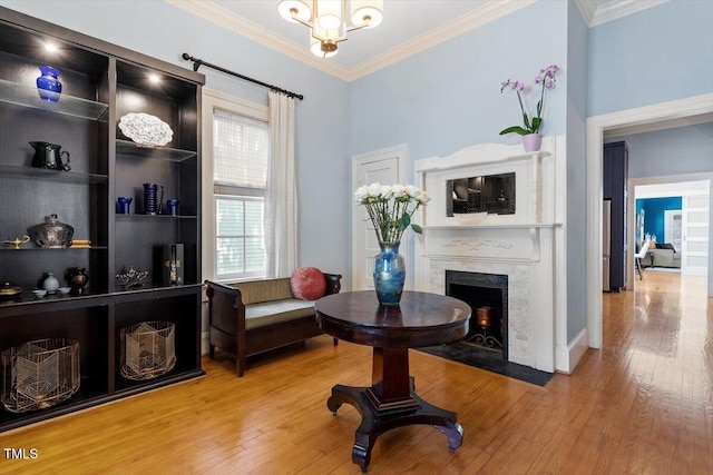 216 N Bloodworth St, Raleigh, NC 27601 - sitting room with crown molding, a fireplace with flush hearth, and wood finished floors