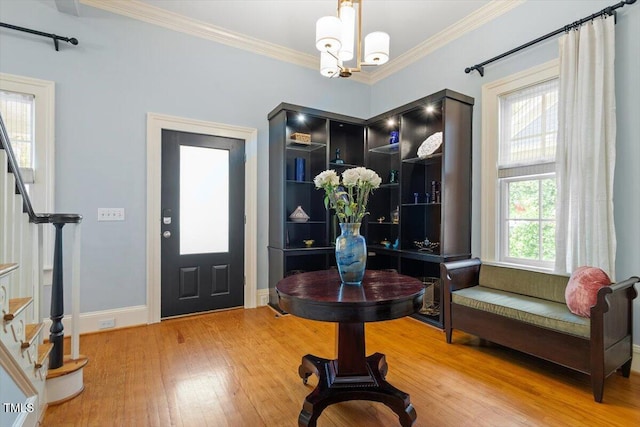 216 N Bloodworth St, Raleigh, NC 27601 - entrance foyer with crown molding, light wood-type flooring, stairway, baseboards, and a chandelier