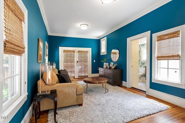 216 N Bloodworth St, Raleigh, NC 27601 - sitting room featuring crown molding, wood finished floors, and a healthy amount of sunlight