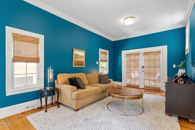 216 N Bloodworth St, Raleigh, NC 27601 - living area featuring plenty of natural light, ornamental molding, french doors, and wood finished floors