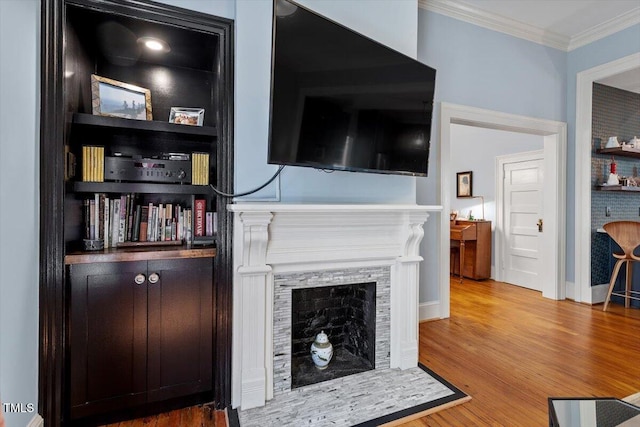 216 N Bloodworth St, Raleigh, NC 27601 - living room featuring baseboards, ornamental molding, a fireplace, and wood finished floors