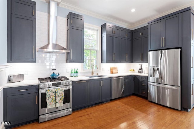216 N Bloodworth St, Raleigh, NC 27601 - kitchen featuring light countertops, wall chimney exhaust hood, a sink, backsplash, and stainless steel appliances