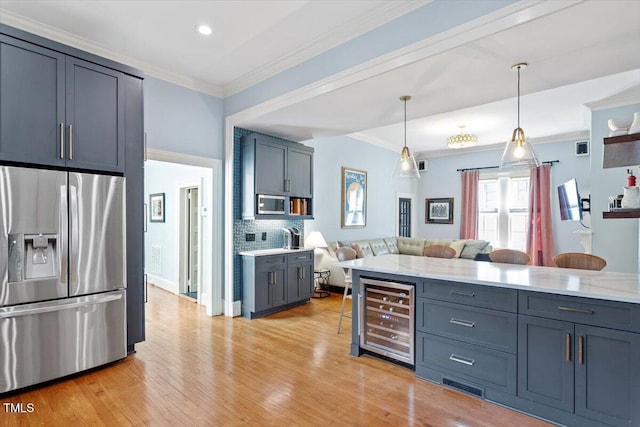 216 N Bloodworth St, Raleigh, NC 27601 - kitchen with crown molding, stainless steel appliances, open floor plan, and beverage cooler