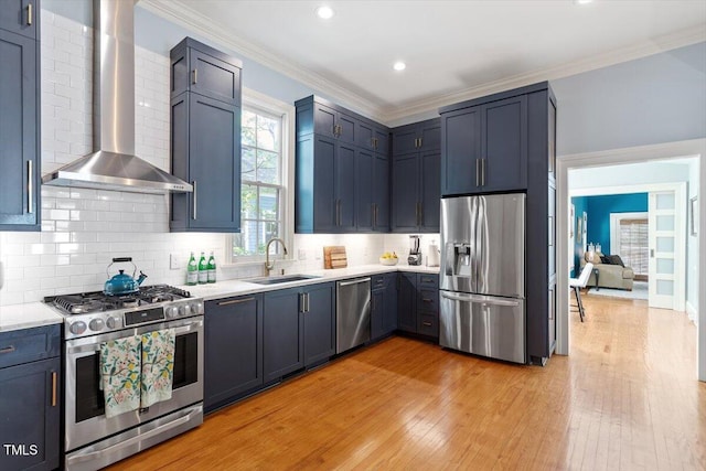 216 N Bloodworth St, Raleigh, NC 27601 - kitchen featuring wall chimney range hood, light countertops, a sink, light wood finished floors, and stainless steel appliances