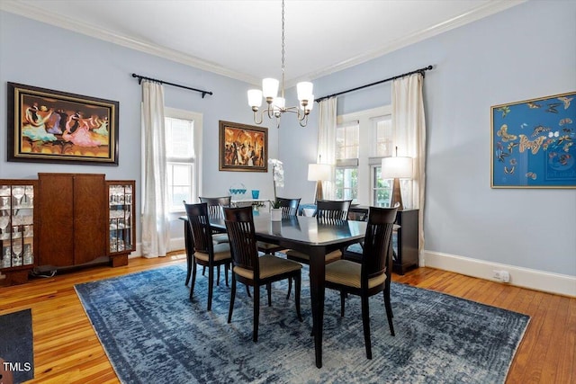 216 N Bloodworth St, Raleigh, NC 27601 - dining room with crown molding, baseboards, an inviting chandelier, and wood finished floors