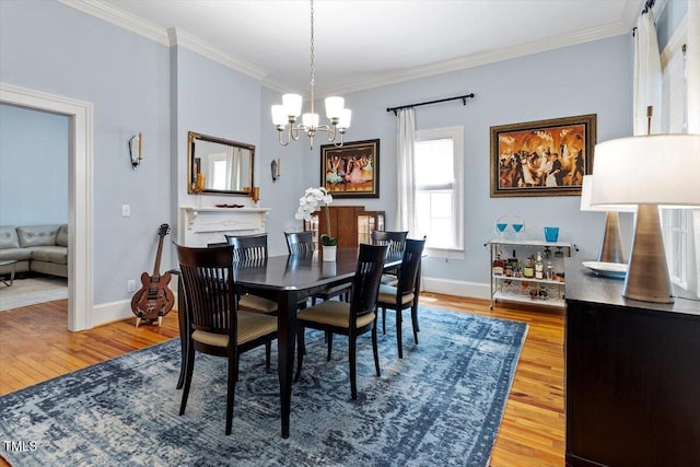 216 N Bloodworth St, Raleigh, NC 27601 - dining area with light wood-style floors, crown molding, and a notable chandelier