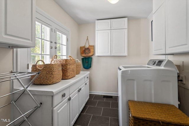 216 N Bloodworth St, Raleigh, NC 27601 - washroom featuring cabinet space, dark tile patterned floors, baseboards, and washer and clothes dryer