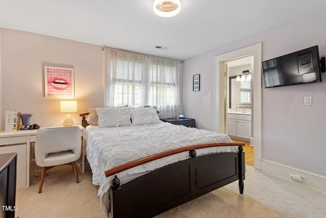 216 N Bloodworth St, Raleigh, NC 27601 - bedroom with light colored carpet, connected bathroom, and visible vents