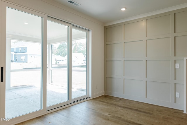 3521 Amelia Grace Dr Lot 67, Fuquay Varina, NC 27526 - spare room with a decorative wall, crown molding, and light wood-type flooring