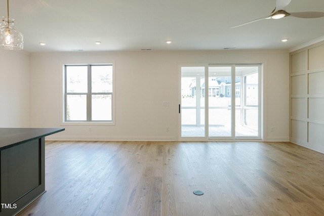 3521 Amelia Grace Dr Lot 67, Fuquay Varina, NC 27526 - unfurnished living room featuring healthy amount of natural light, ceiling fan, ornamental molding, light wood-type flooring, and baseboards