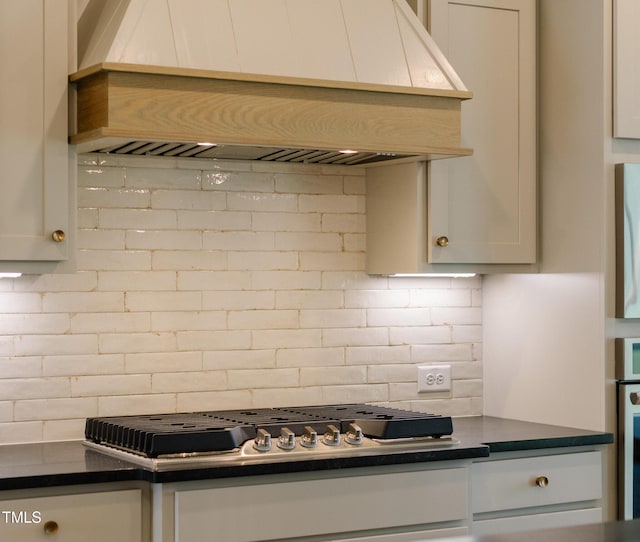 3521 Amelia Grace Dr Lot 67, Fuquay Varina, NC 27526 - kitchen featuring custom exhaust hood, decorative backsplash, dark countertops, and stainless steel gas cooktop