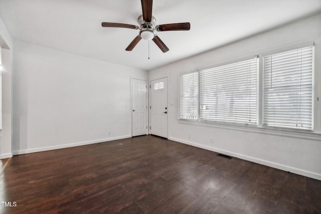 foyer entrance with baseboards, visible vents, ceiling fan, and wood finished floors