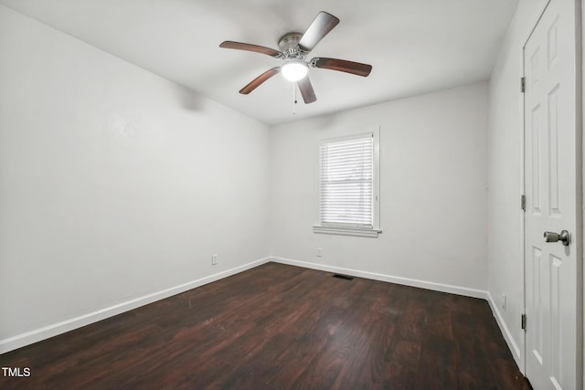 unfurnished bedroom with ceiling fan, visible vents, baseboards, and dark wood finished floors