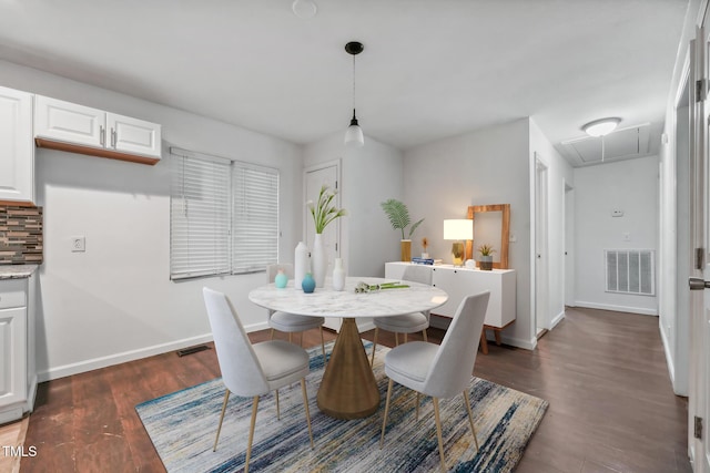 dining space featuring baseboards, dark wood-style flooring, visible vents, and attic access