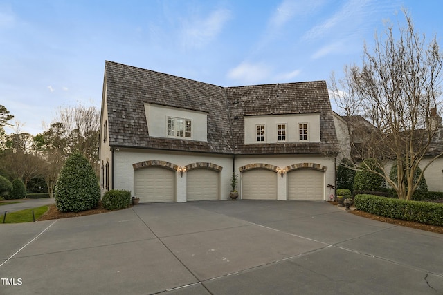 view of front of house with brick siding, driveway, and a garage