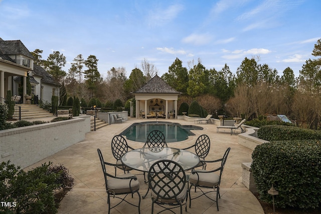 pool featuring outdoor dining space, a patio, an outdoor structure, and an exterior structure