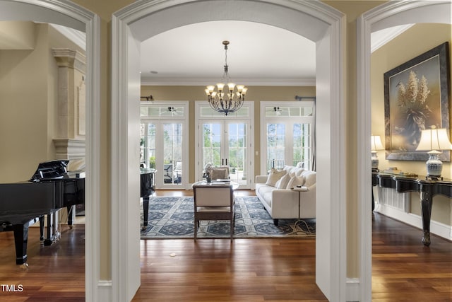 living room featuring a chandelier, wood finished floors, and ornamental molding