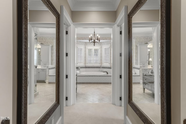 hallway featuring carpet flooring, a chandelier, crown molding, and wallpapered walls