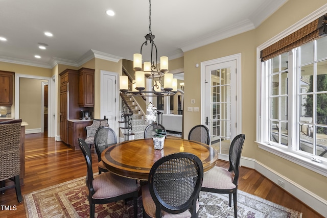 dining room featuring stairs, a healthy amount of sunlight, dark wood-style flooring, and baseboards