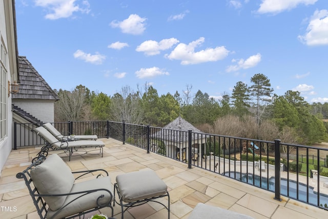 view of patio / terrace with a fenced in pool