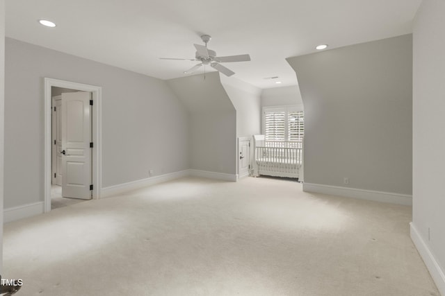 additional living space featuring baseboards, lofted ceiling, recessed lighting, ceiling fan, and light carpet