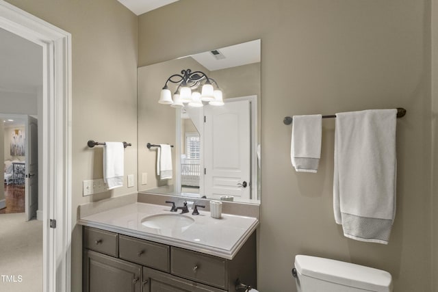 bathroom featuring toilet and vanity