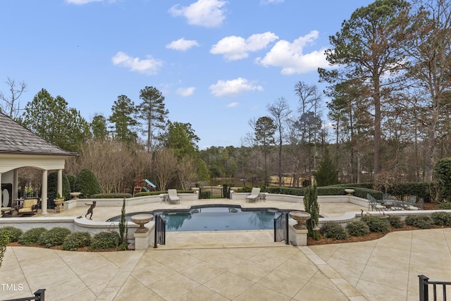 outdoor pool with a patio area