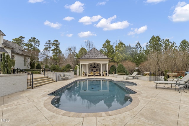 view of swimming pool with a patio area and a gazebo