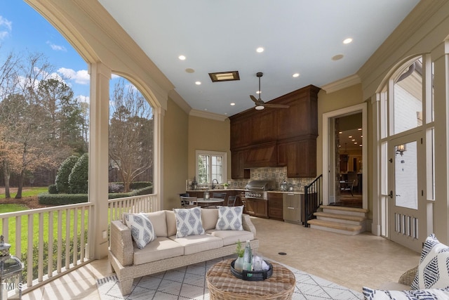 living area with recessed lighting and ornamental molding