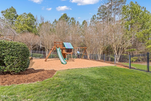 community jungle gym with a yard and fence