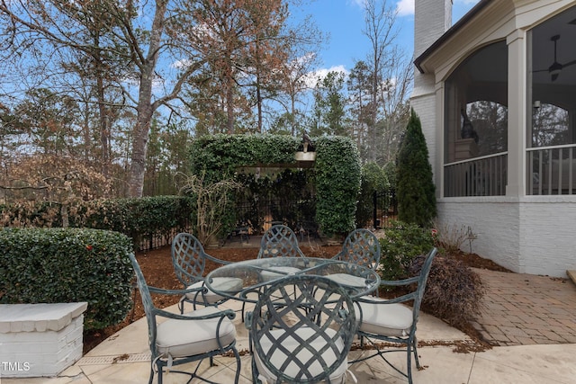 view of patio featuring outdoor dining space and fence