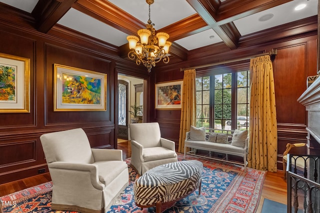 sitting room featuring beam ceiling, a chandelier, and coffered ceiling