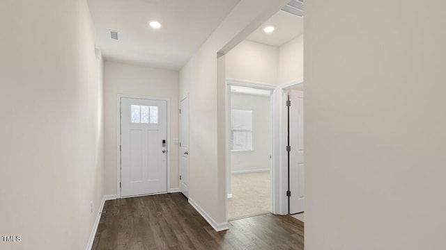 doorway featuring recessed lighting, dark wood-style flooring, visible vents, and baseboards