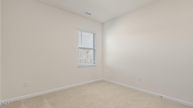 unfurnished room with light carpet, visible vents, and baseboards