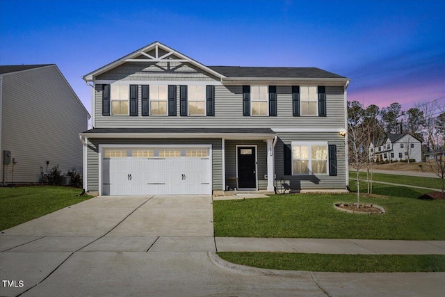 view of front of property with a garage and a lawn