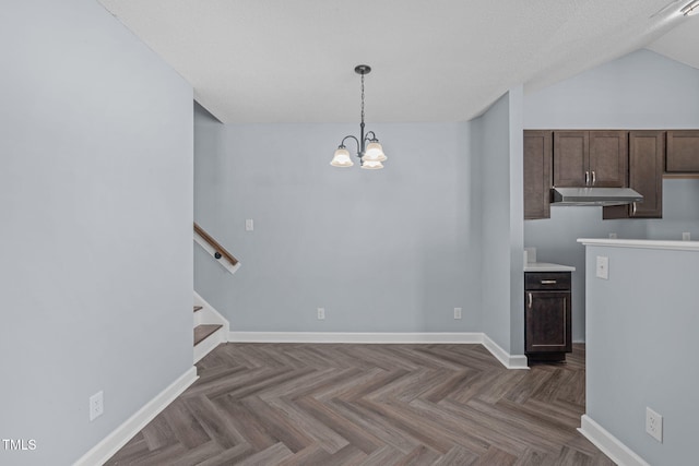 interior space with an inviting chandelier, baseboards, stairway, and vaulted ceiling