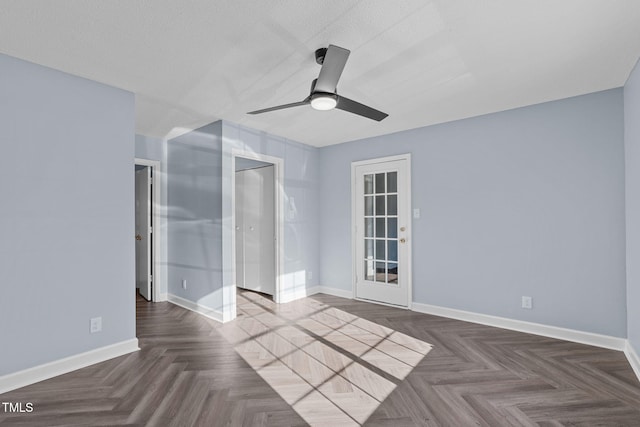 unfurnished bedroom with a ceiling fan, a textured ceiling, and baseboards