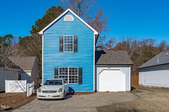 view of front of home with a garage, driveway, and a shingled roof